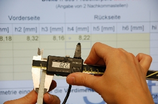 Mean combined thickness of a liner is measured using a precision slide gauge