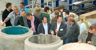 a group of people inspecting renovated sewer manholes