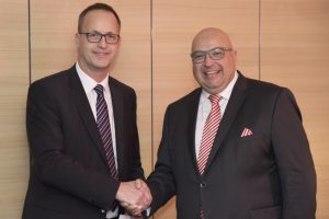 two men in suits shaking hands