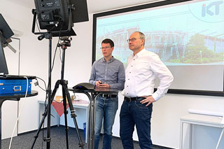 two men in front of screen