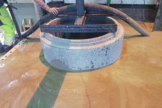 concrete manhole in test stand filled with flowable backfill